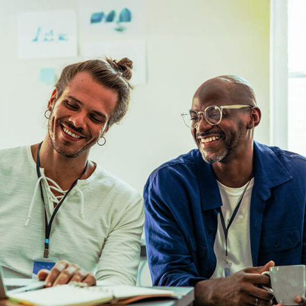 Young diverse coworkers discussing ideas and notes in a collaborative meeting