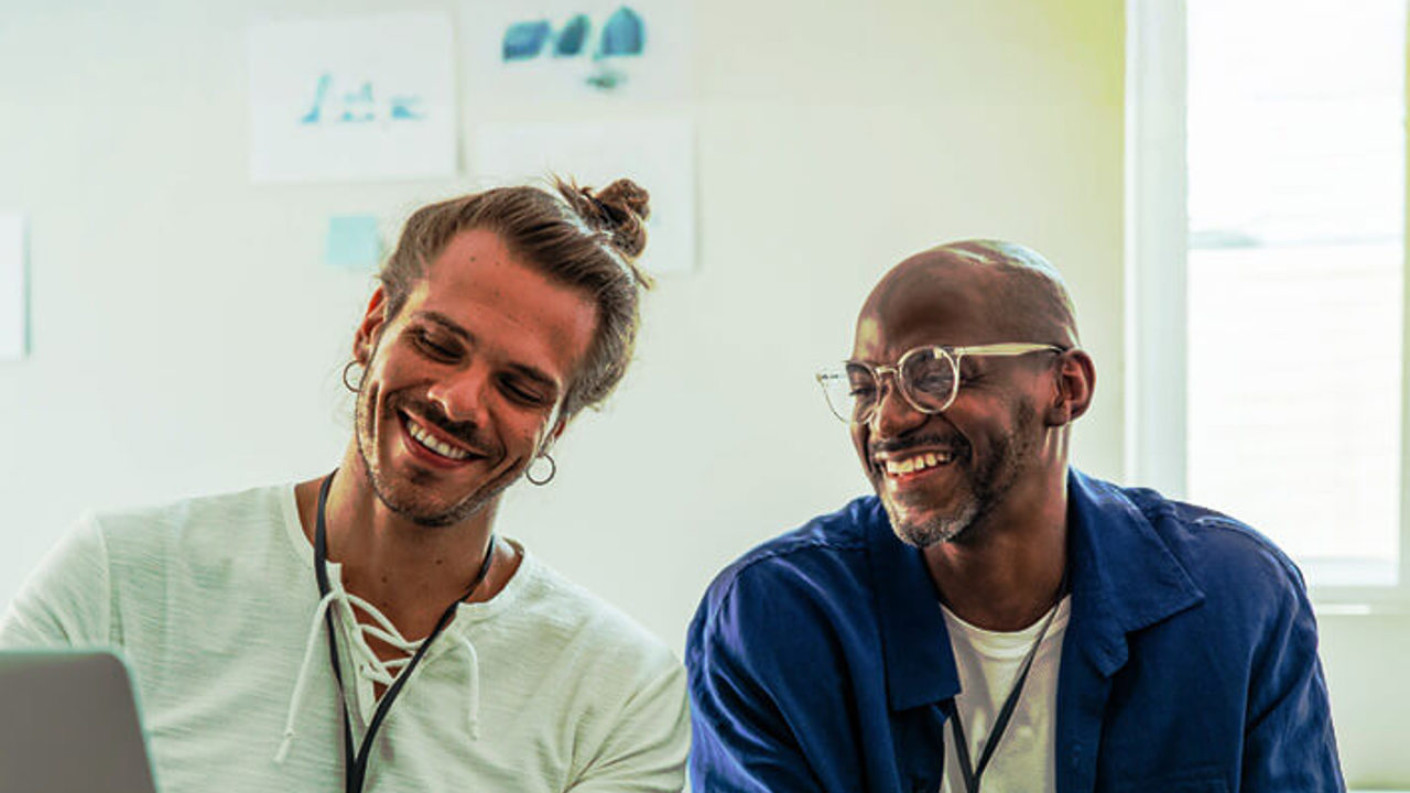 Young diverse coworkers discussing ideas and notes in a collaborative meeting