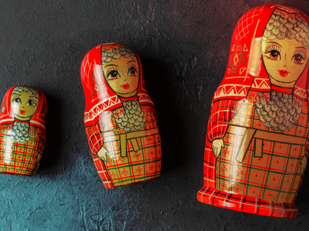 Russian style Matryoshka dolls that laying side by side on a surface.