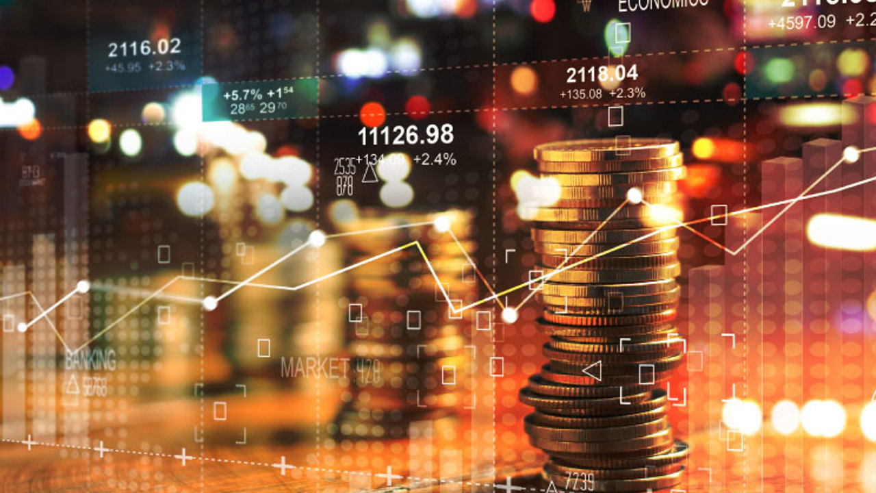 Double exposure with business' charts of graph and rows of coins for finance at night city background.