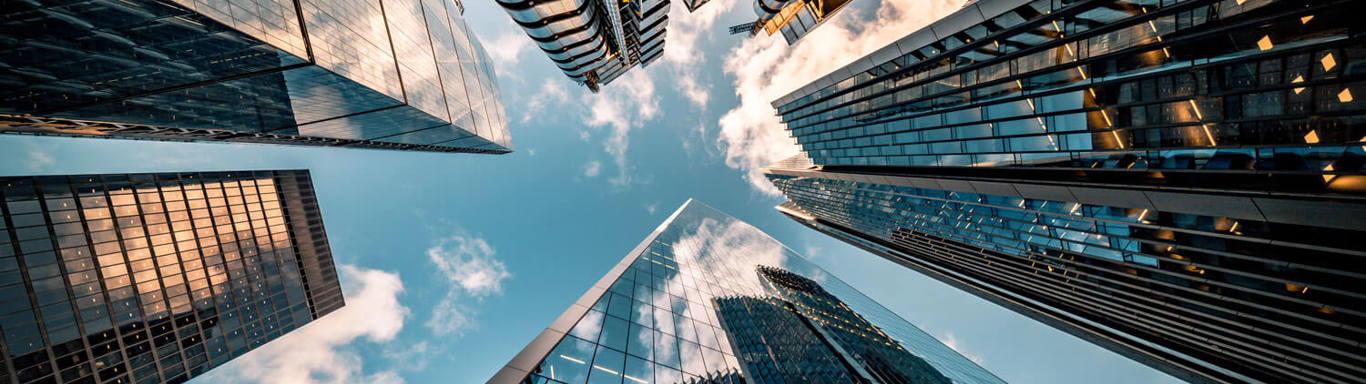 Looking directly up at the skyline of the financial district in central London.