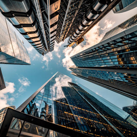 Looking directly up at the skyline of the financial district in central London.