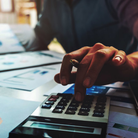 Business accounting concept, Business man using calculator with computer laptop, budget and loan paper in office.