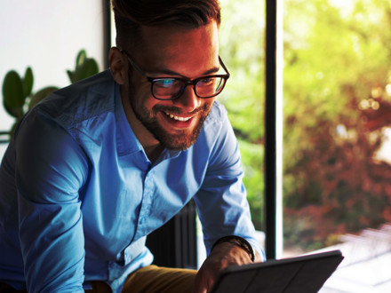 Young man holding digital tablet.