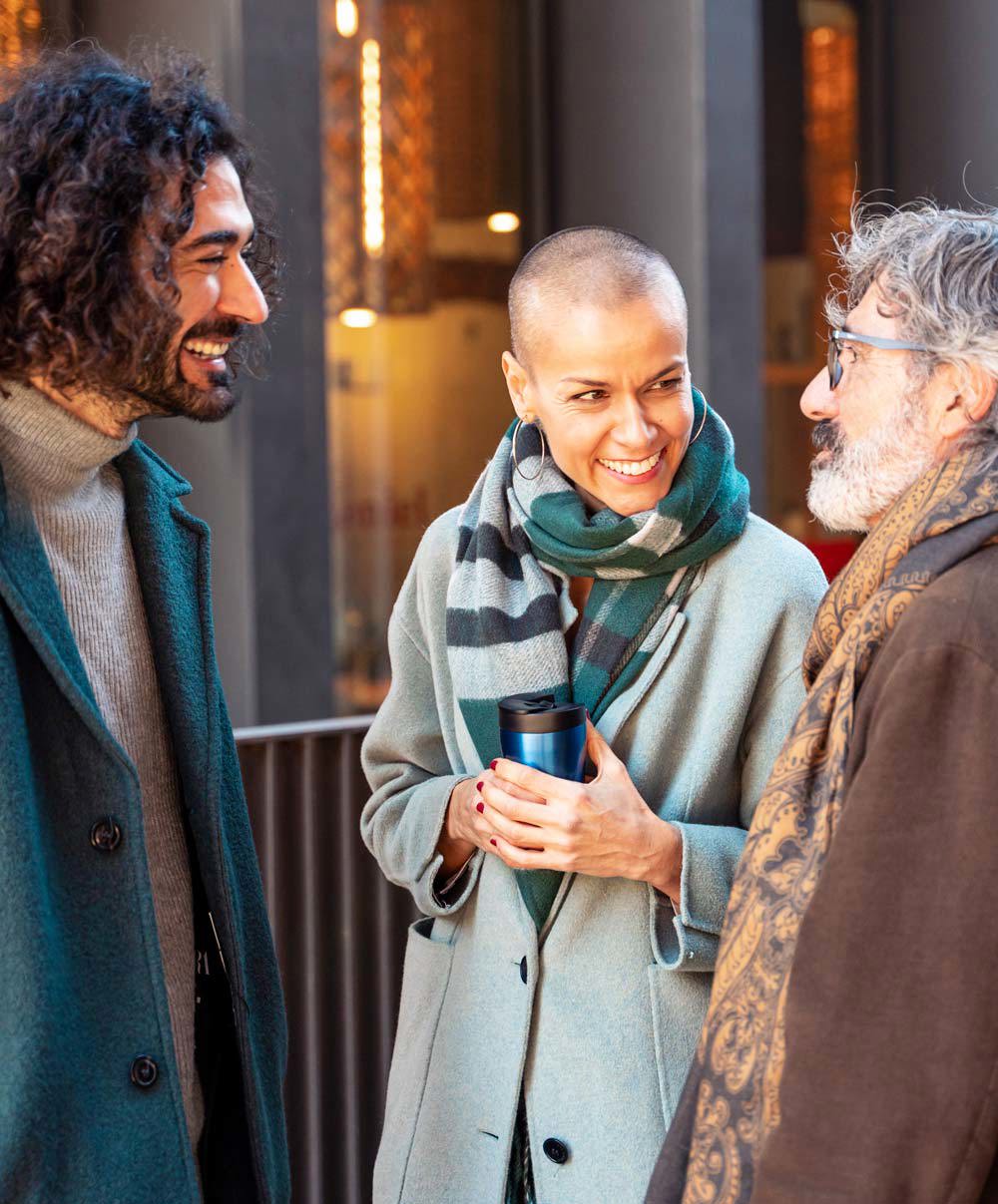 Three multi-cultural co-workers having coffee together. 