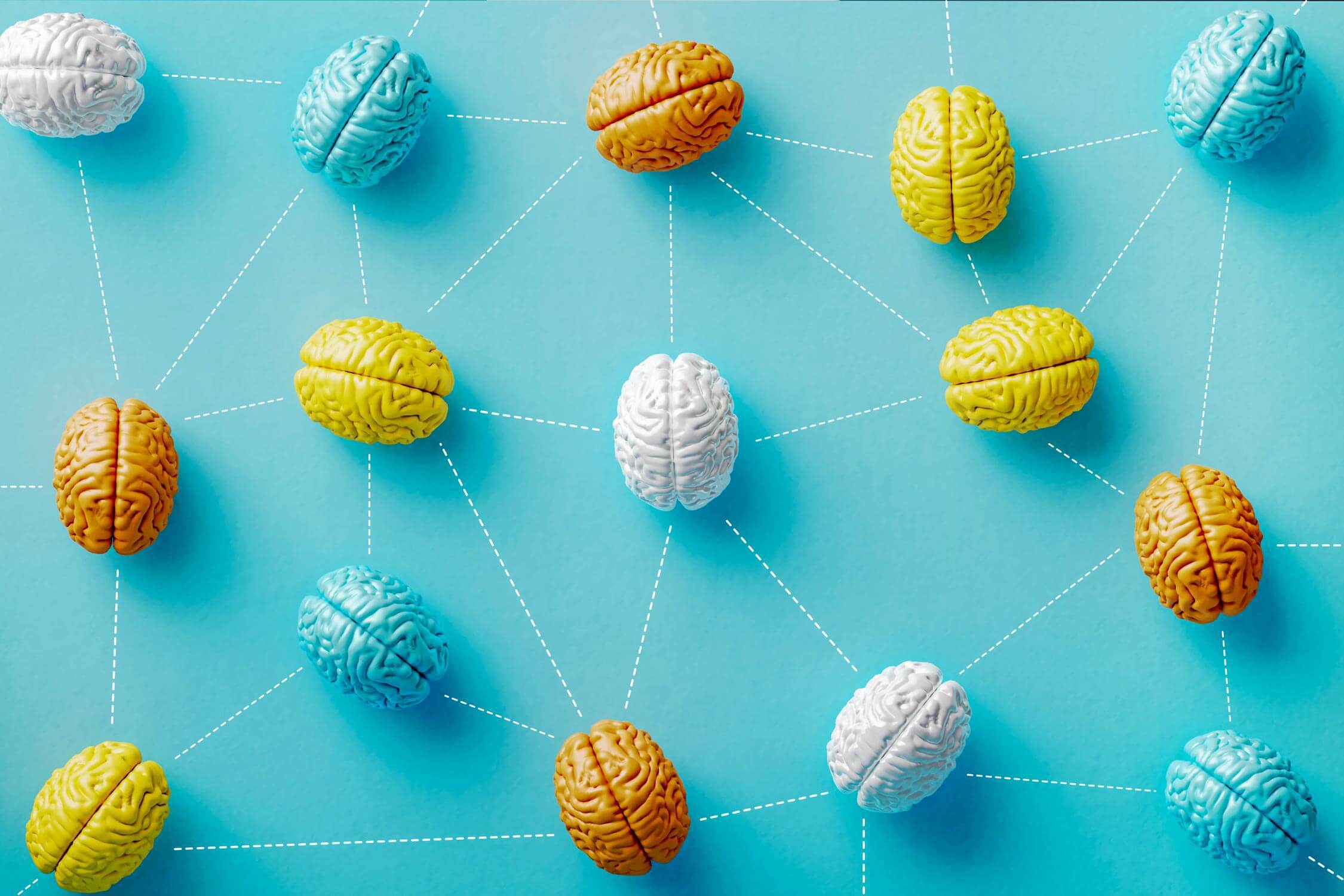 Colorful brain objects connected by dotted lines on blue background. Horizontal composition with copy space. AI and deep learning concept.