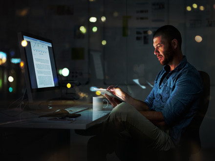 Man at computer developing CRM Strategy 