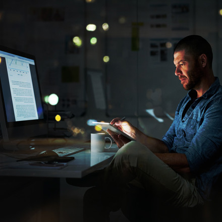 Man at computer developing CRM Strategy 