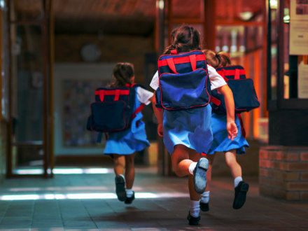 Excited students running towards entrance