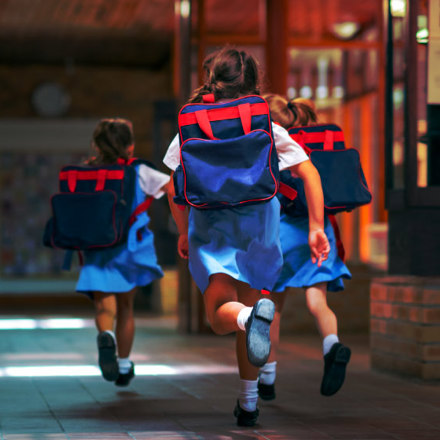 Excited students running towards entrance