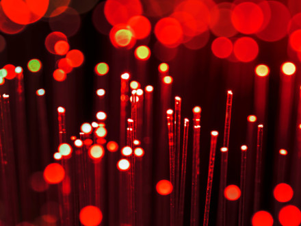 Red fibre optics abstract background. Shallow depth of field. Beautiful bokeh, space for copy.