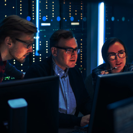 Programmers Talking about Work, Using Computers. Technical Department with Data Server Racks.