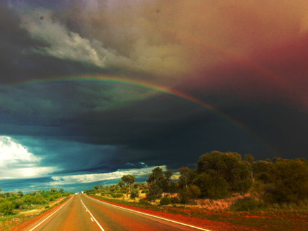 Double rainbow on an open rural road