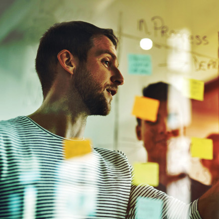 Cropped shot of a group of young designers using sticky notes during a brainstorming session