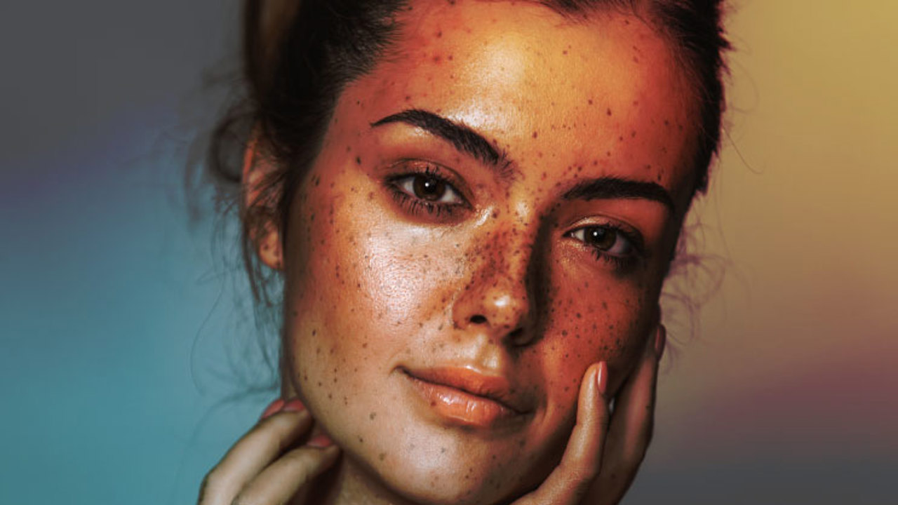 Beautiful young girl with freckle. Studio shot