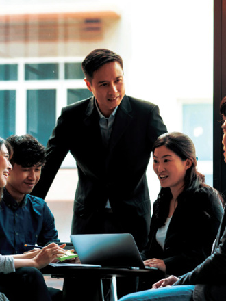 Staff in a boardroom reviewing their business solutions.