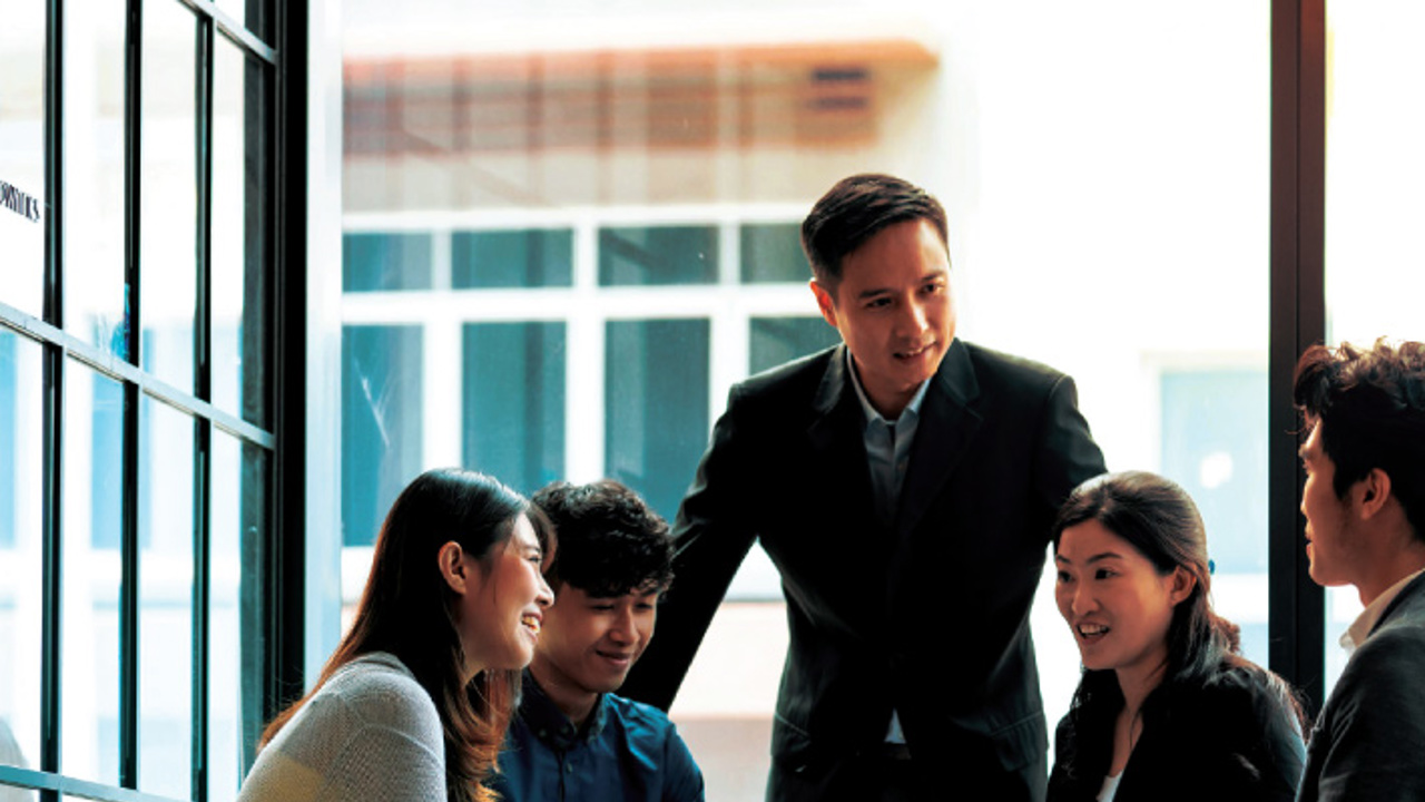 Staff in a boardroom reviewing their business solutions.