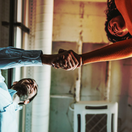 Two people shaking hands.