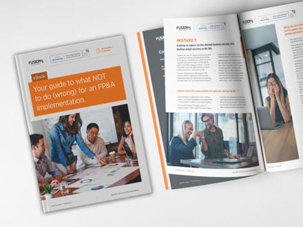 An image of an open eBook titled 'Your guide to what NOT to do (wrong) for an FPandA implementation.' The cover shows people discussing at a table with documents. Inside pages discuss common FP&amp;A mistakes with text and images.