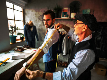 Tailor Taking Measurements of his Customer