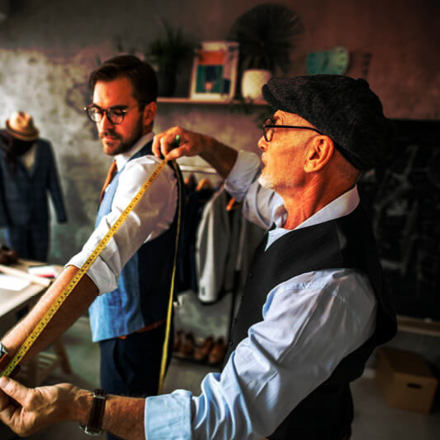 Tailor Taking Measurements of his Customer