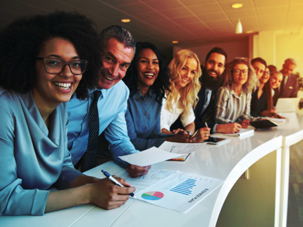 Cheerful multiracial colleagues looking at camera in office.