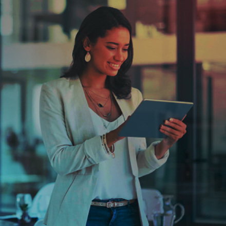 Business woman smiling and working on her tablet.