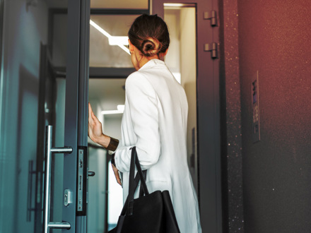 Woman entering residential building.