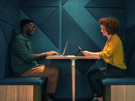 Young business people working in modern co-working space office using digital devices