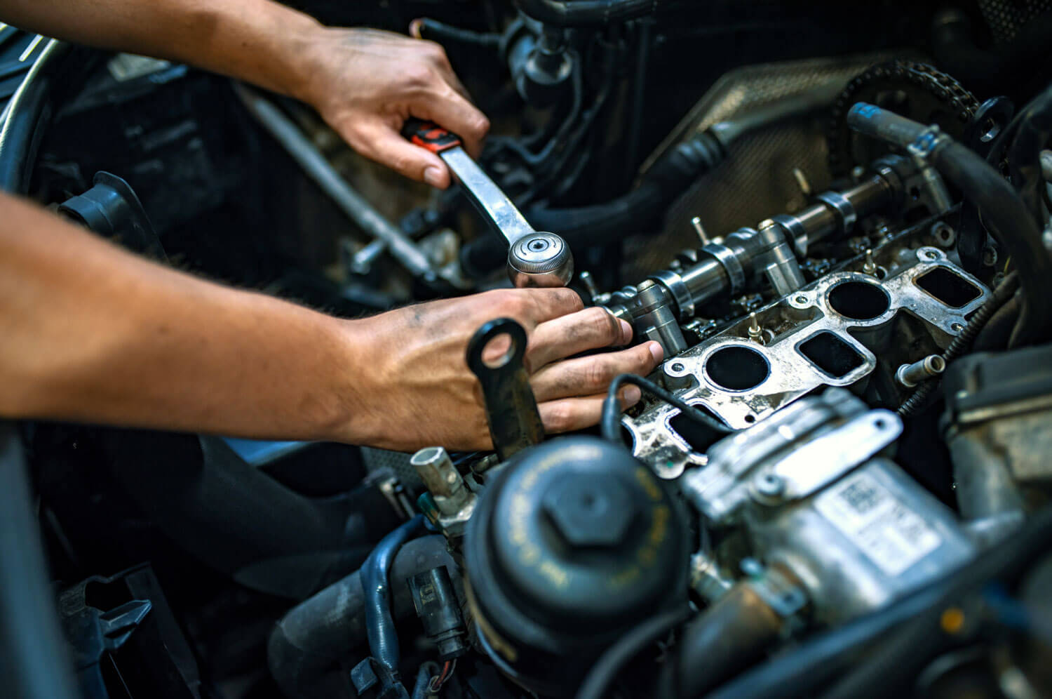 Mechanic using a ratchet wrench.