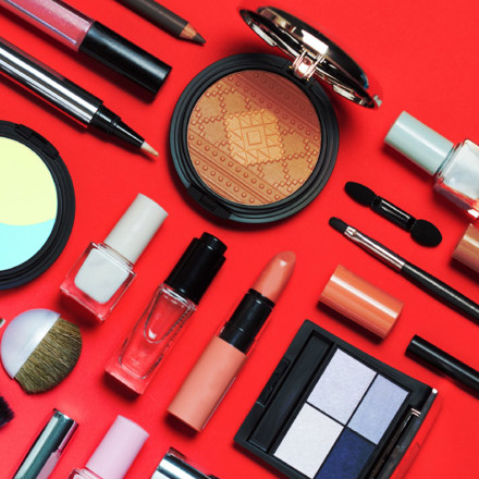 Beauty, decorative cosmetics, flat lay, top view, minimalistic style with red background.