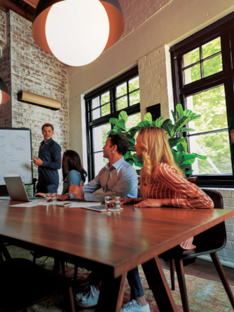 Business Solutions discussion by staff in a boardroom.