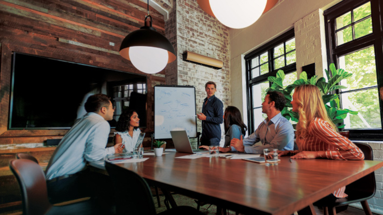 Business Solutions discussion by staff in a boardroom.