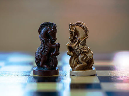 Two chess knights facing each other on the chess board