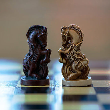 Two chess knights facing each other on the chess board