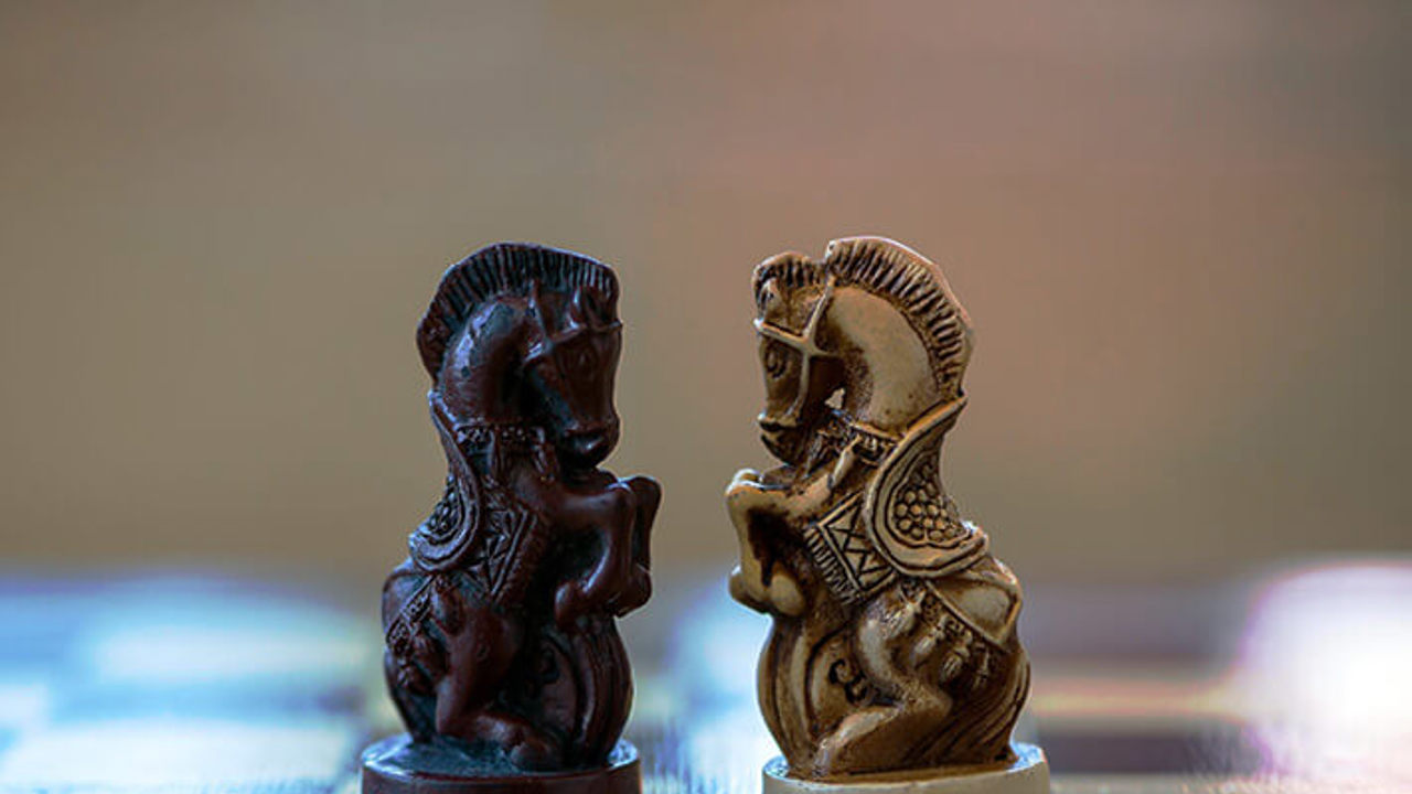 Two chess knights facing each other on the chess board