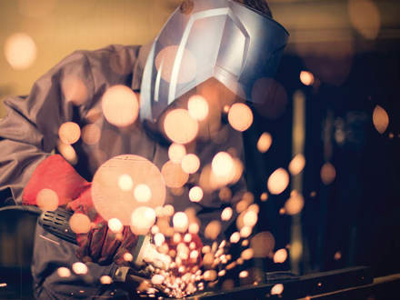 Worker welding steel.