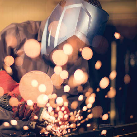 Worker welding steel.