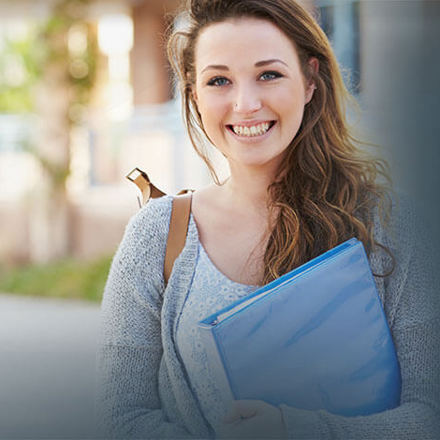 Female student carrying a file. 