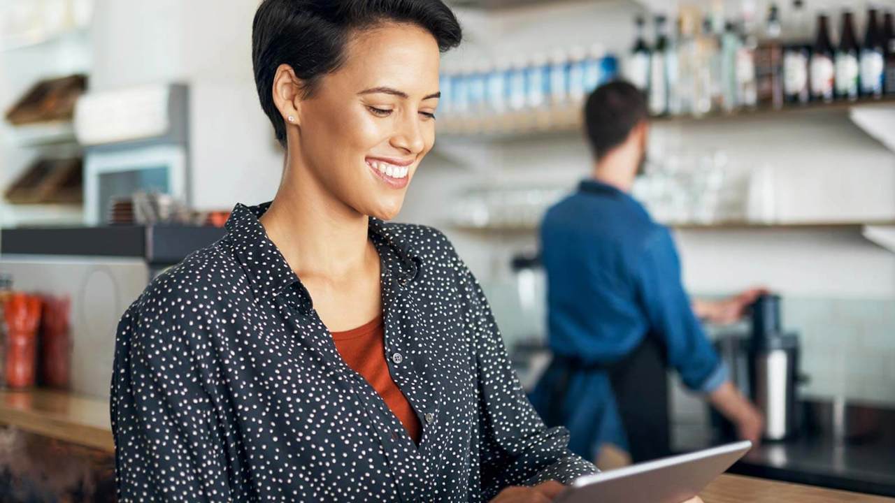 Woman looking at tablet in small business