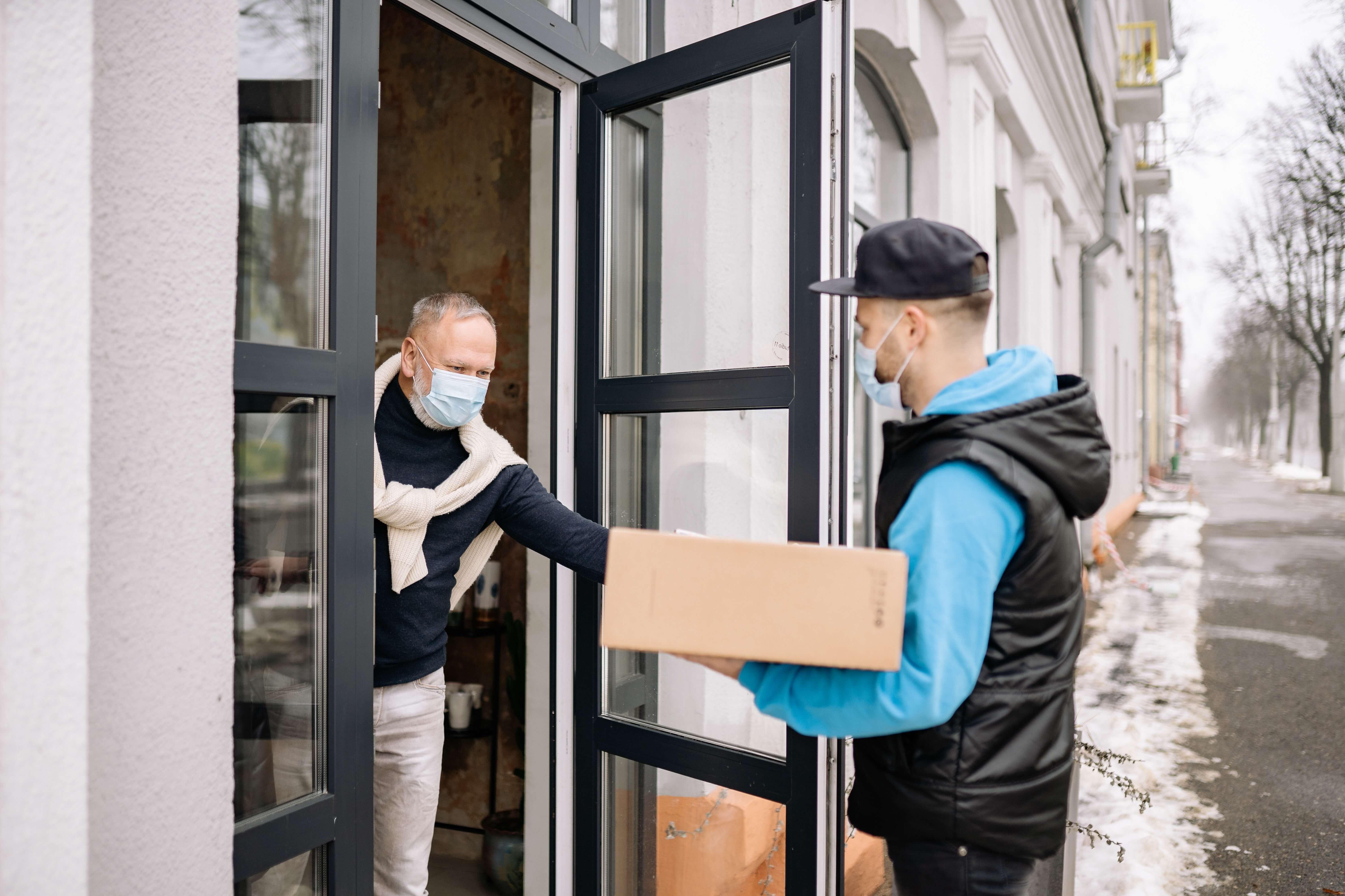 Man receiving a delivery during the pandemic.