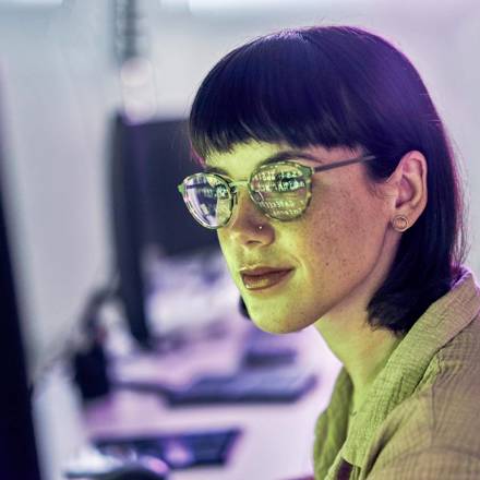 Night, reflection and neon with woman at computer for programmer, cloud computing and software developer. Coding, cybersecurity and technology with employee in digital agency for it, designer or code.