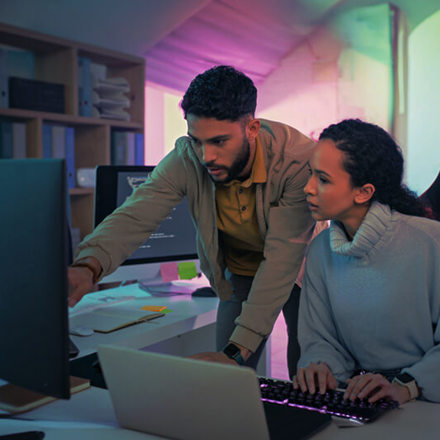 Programmer, computer and software coding team work on database, website or cloud computing algorithm code. Developer, partnership and collaboration of black woman and man on cybersecurity programming