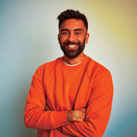 Indian man in orange jumper