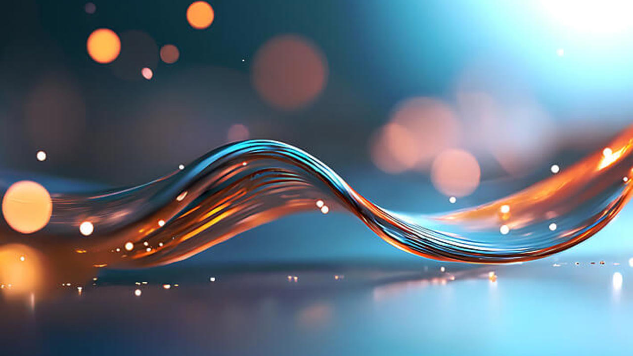 A luminous abstract wave with intertwined blue and orange lines set against a soft-focus background with glowing bokeh lights. The overall atmosphere is ethereal and dynamic.